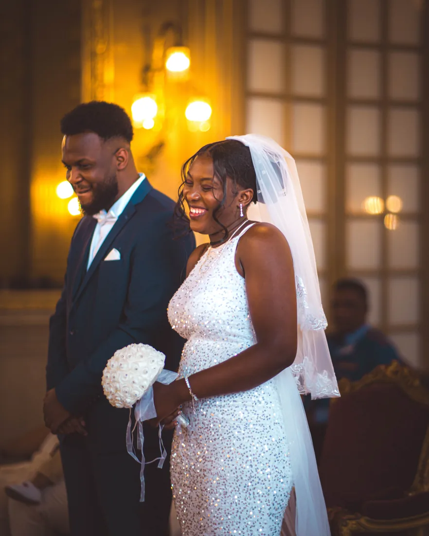 A couple laughing together at the altar