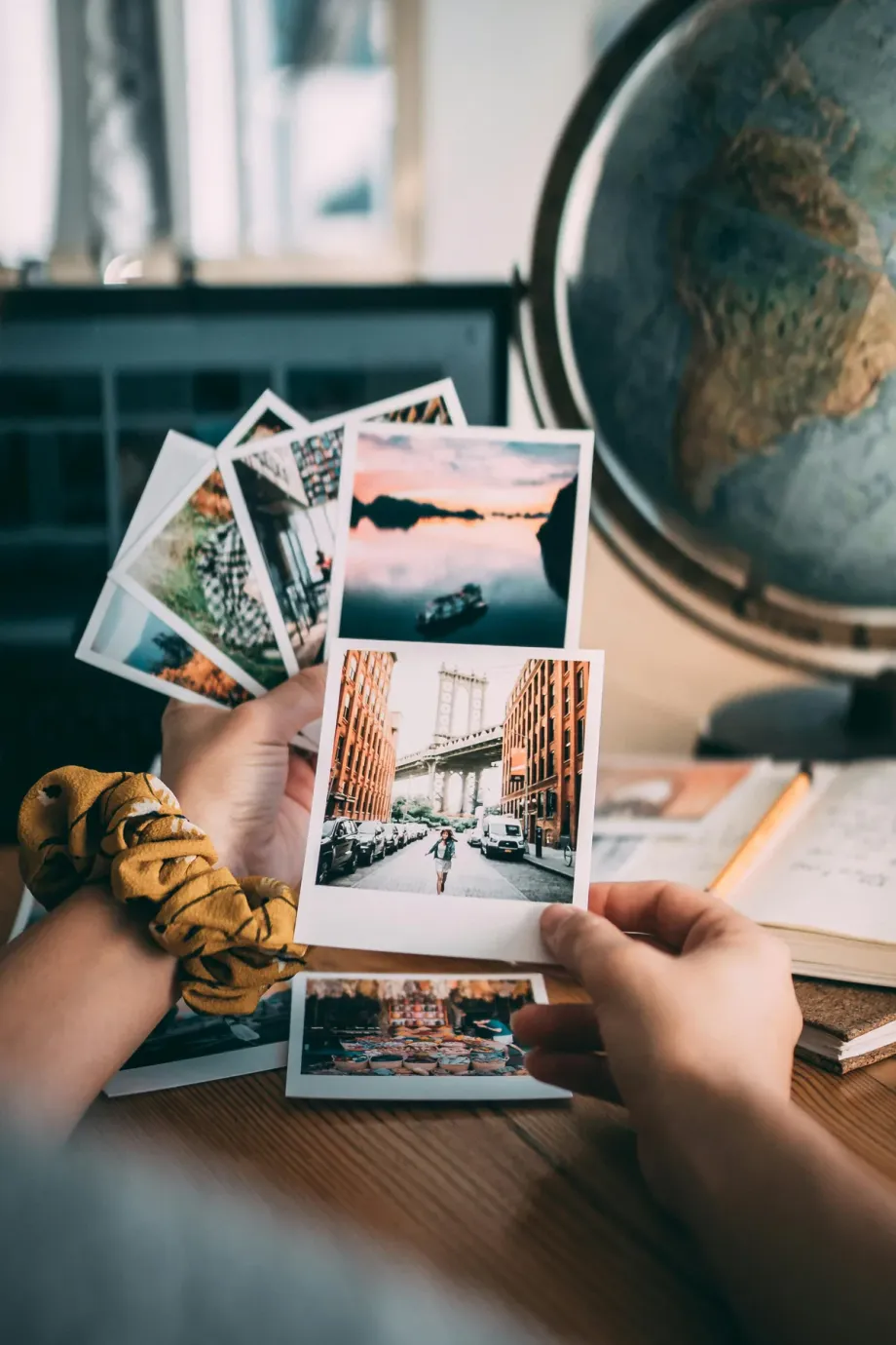 Hands holding printed photo memories