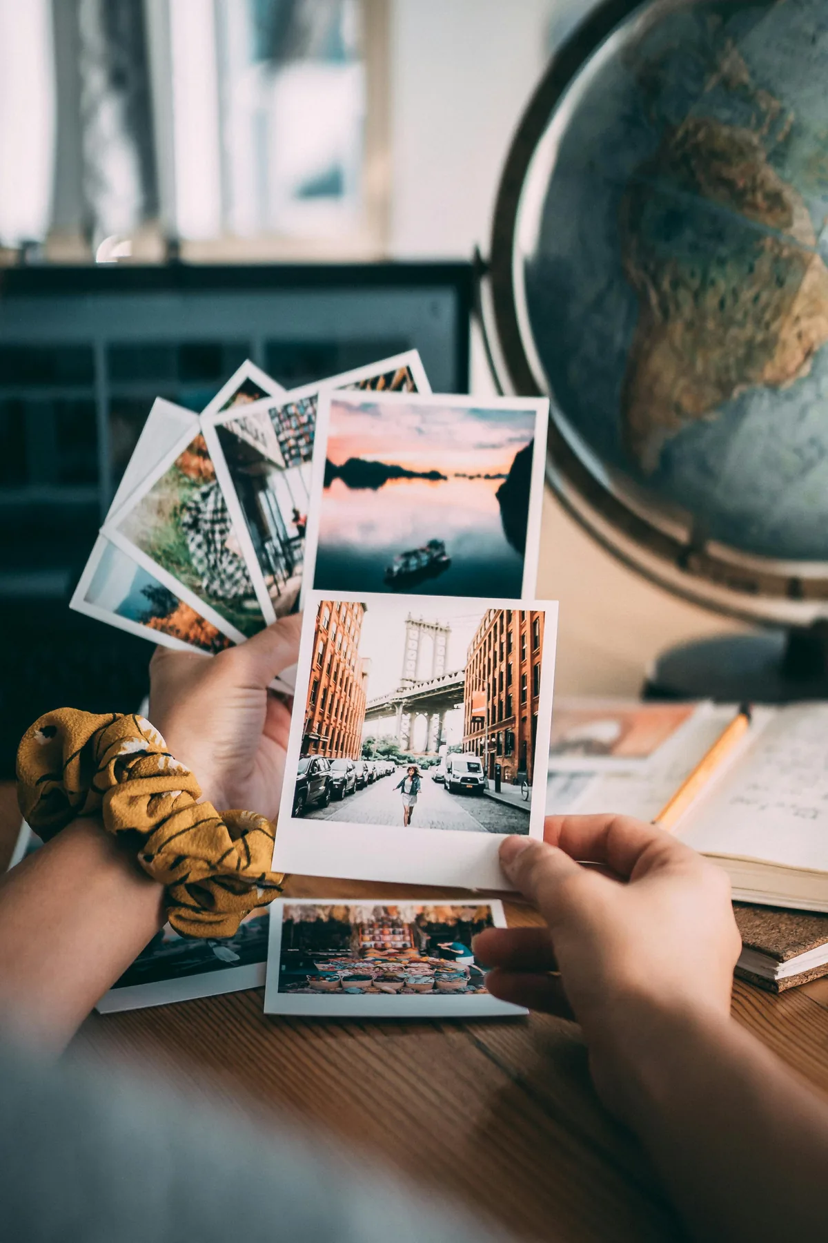 Hands holding printed photo memories